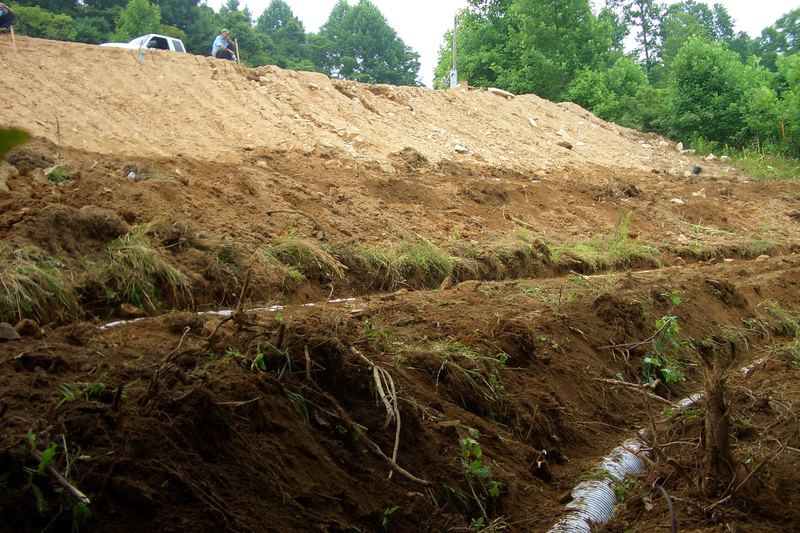 Cross-section of a pipe trench on a graded slope